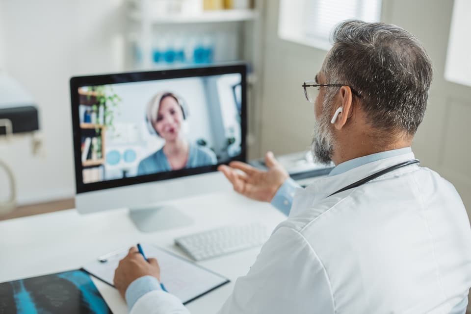 Patient meeting a TRT Optima physician in a telehealth consultation